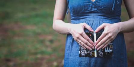 pregnant woman holding her tummy