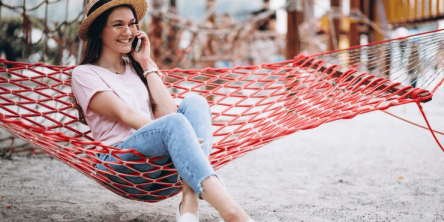 girl on phone in hammock