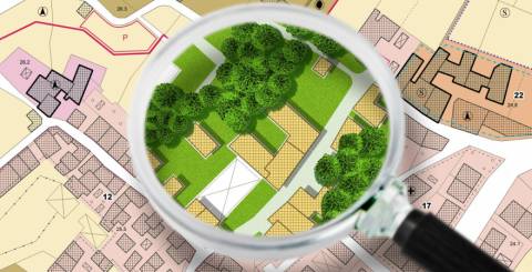 magnifying glass over map of new homes