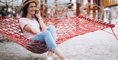 girl on phone in hammock